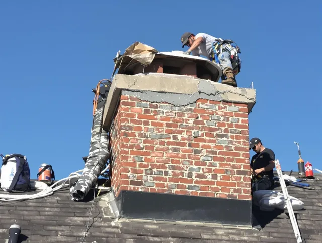 Tyngsborough Chimney Sweep installing a custom chimney crown in Tyngsborough, MA